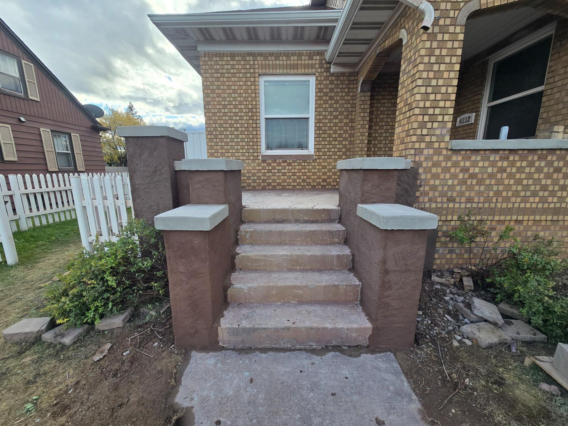 A brick house with stairs leading up to it