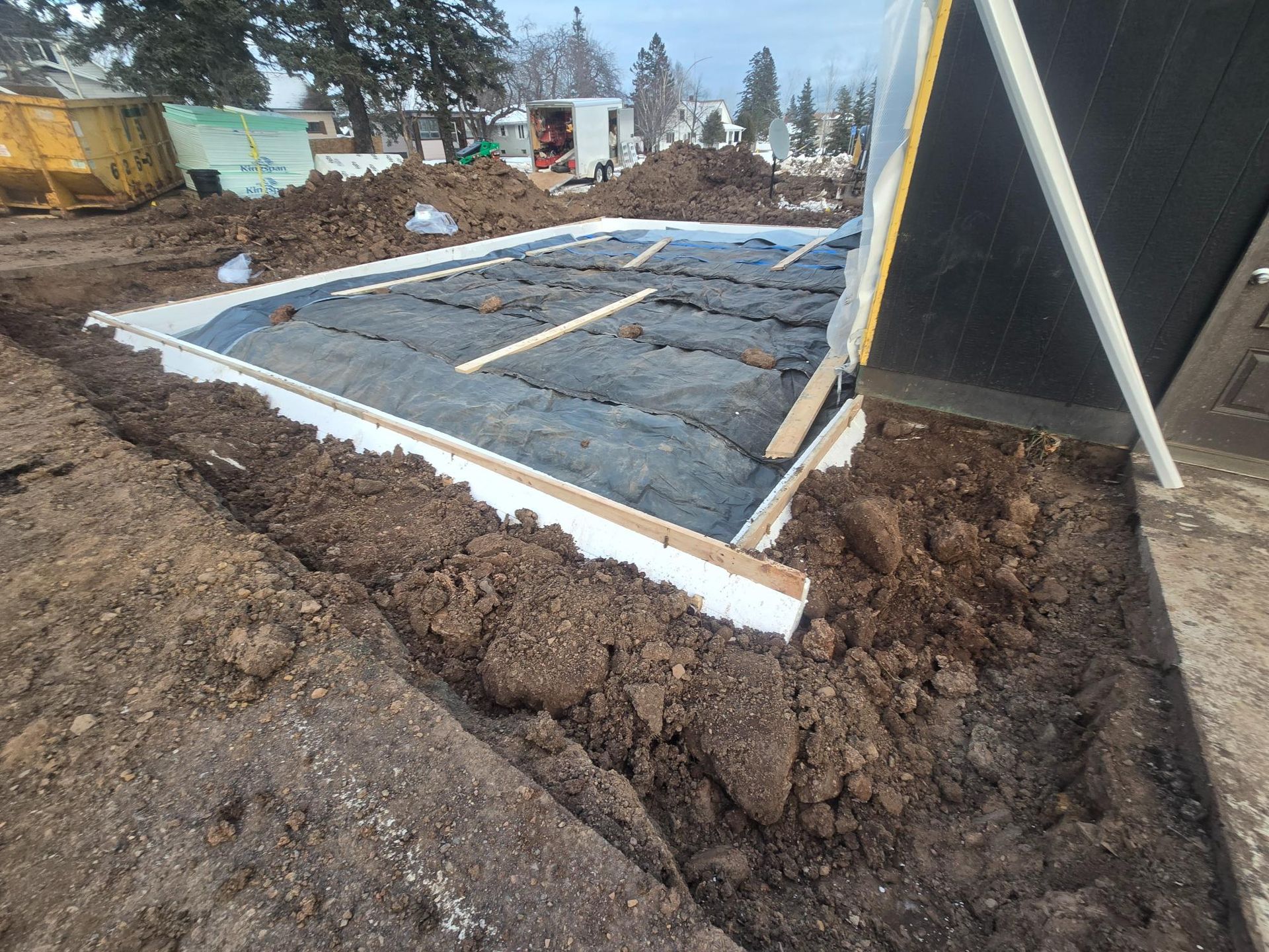 A large pile of dirt is sitting in the middle of a construction site.