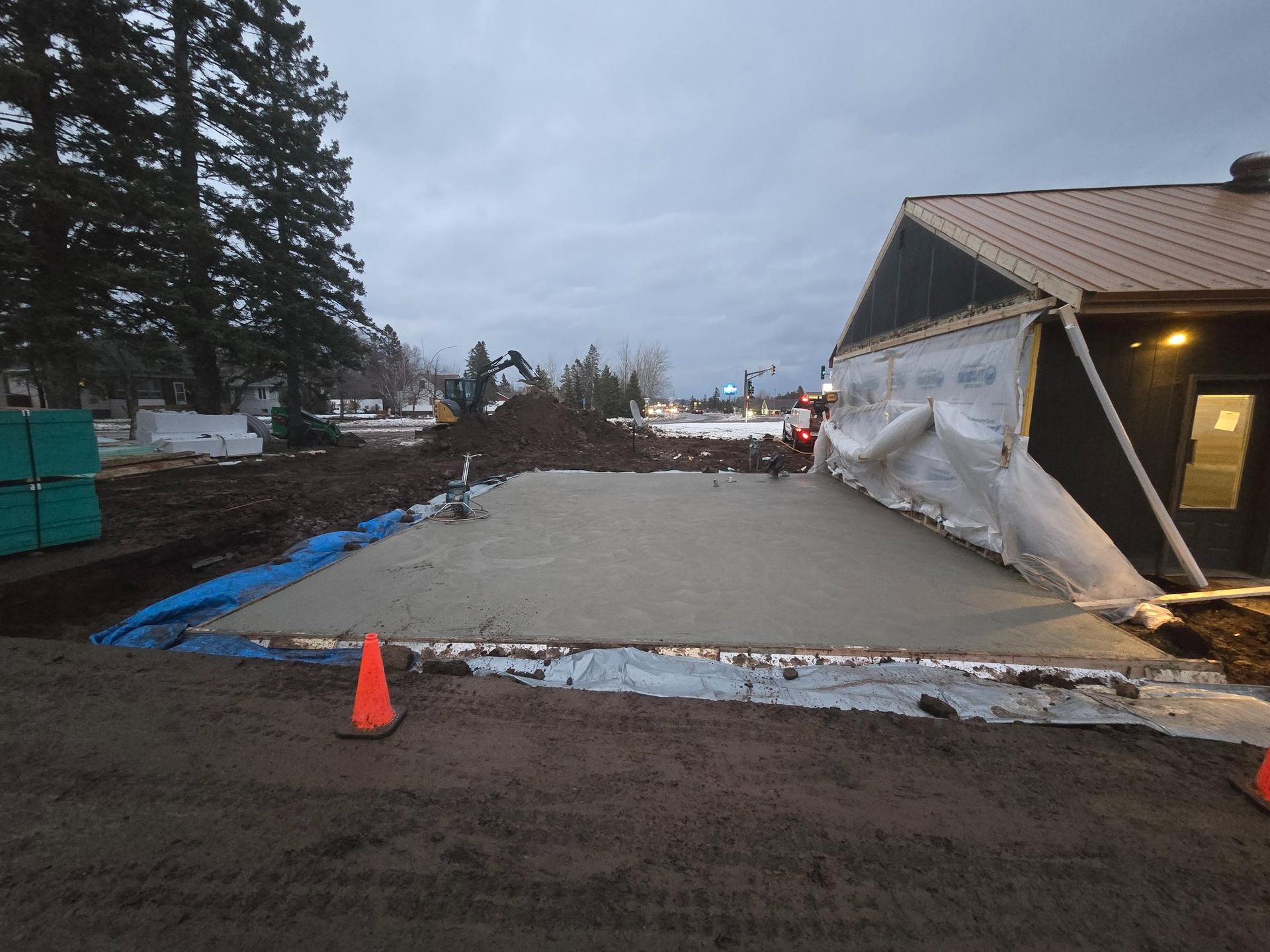 A concrete driveway is being built in front of a building.