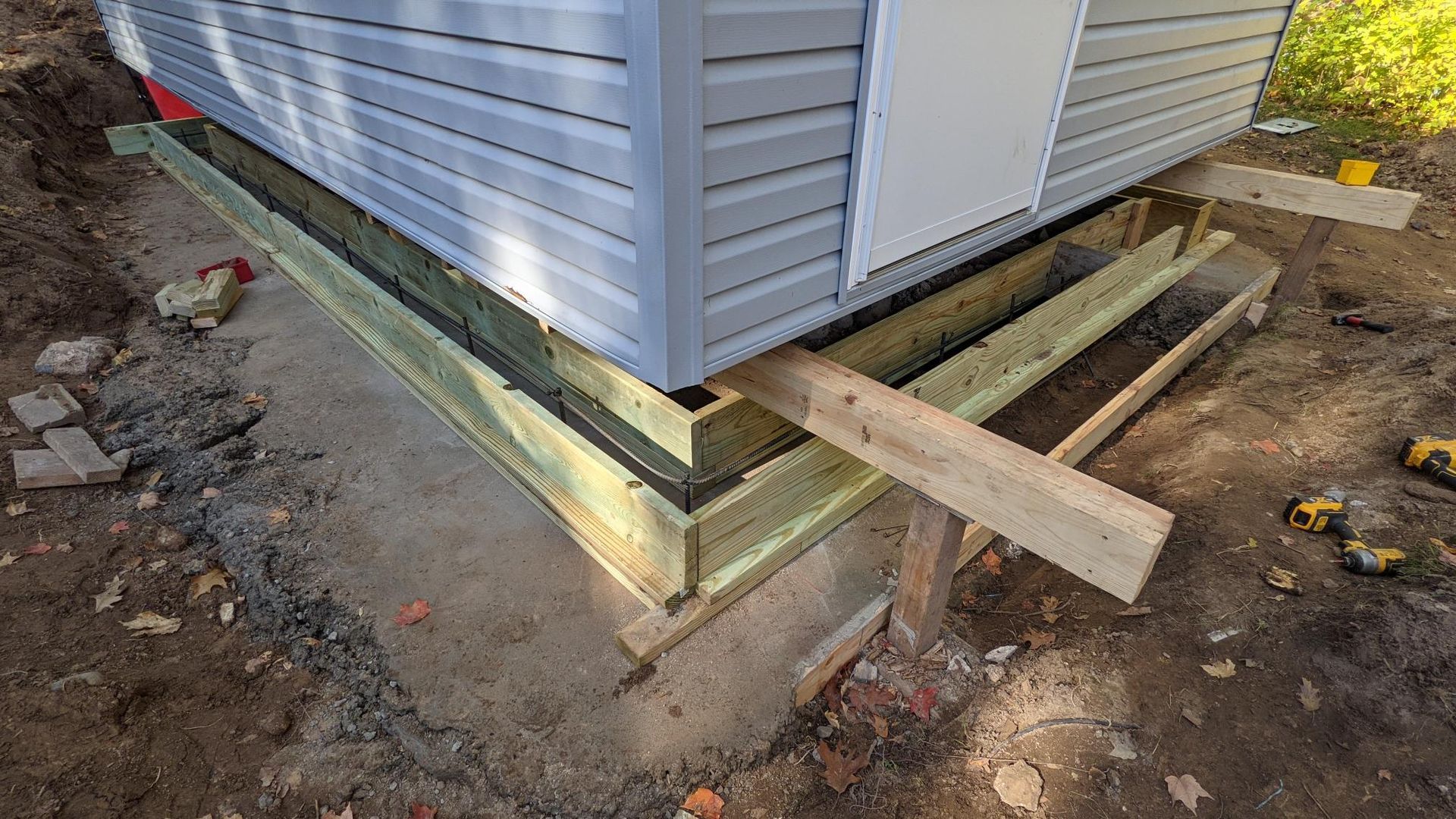 A shed is being built on a concrete foundation.