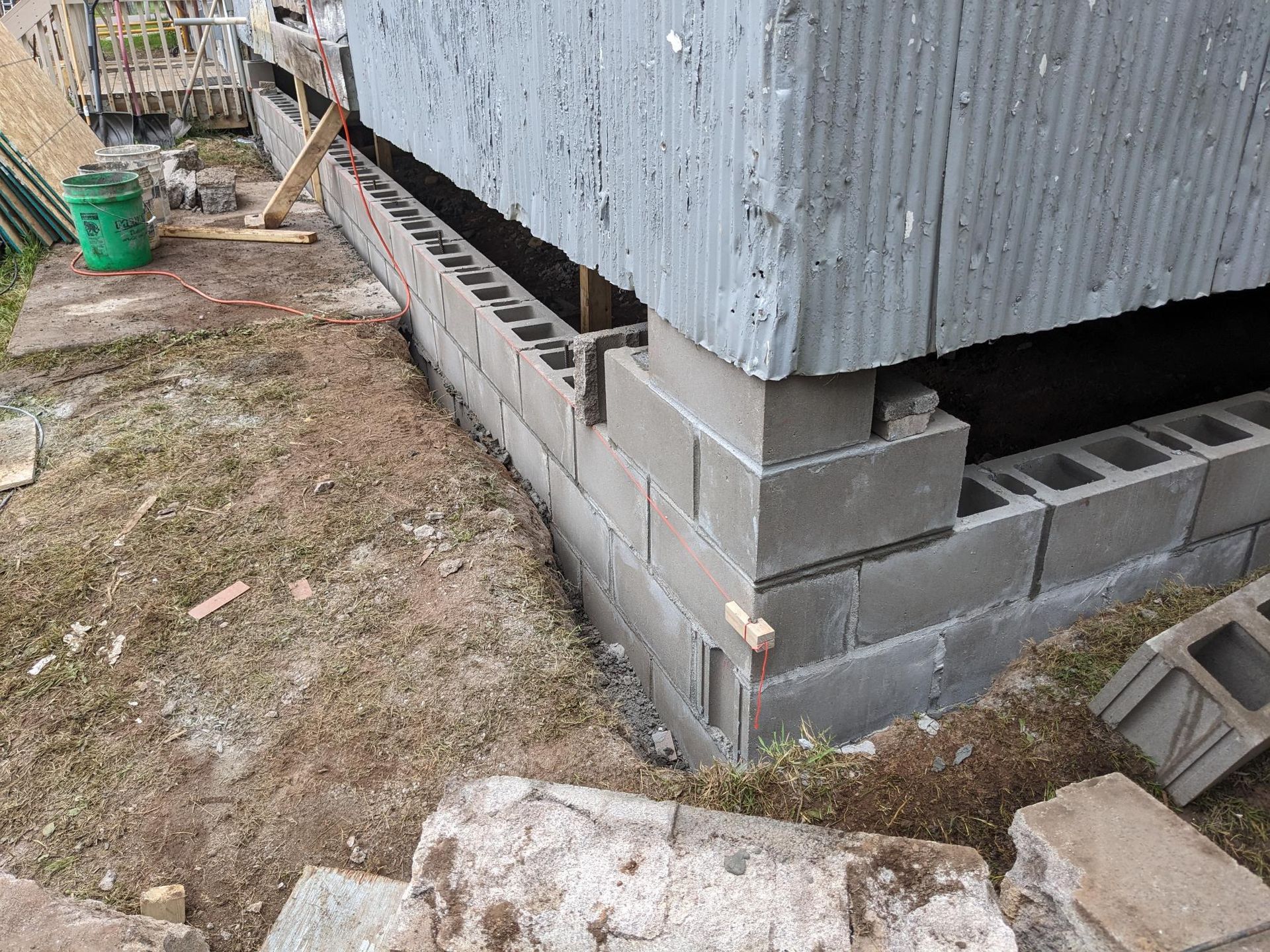 A brick wall is being built on the side of a building.