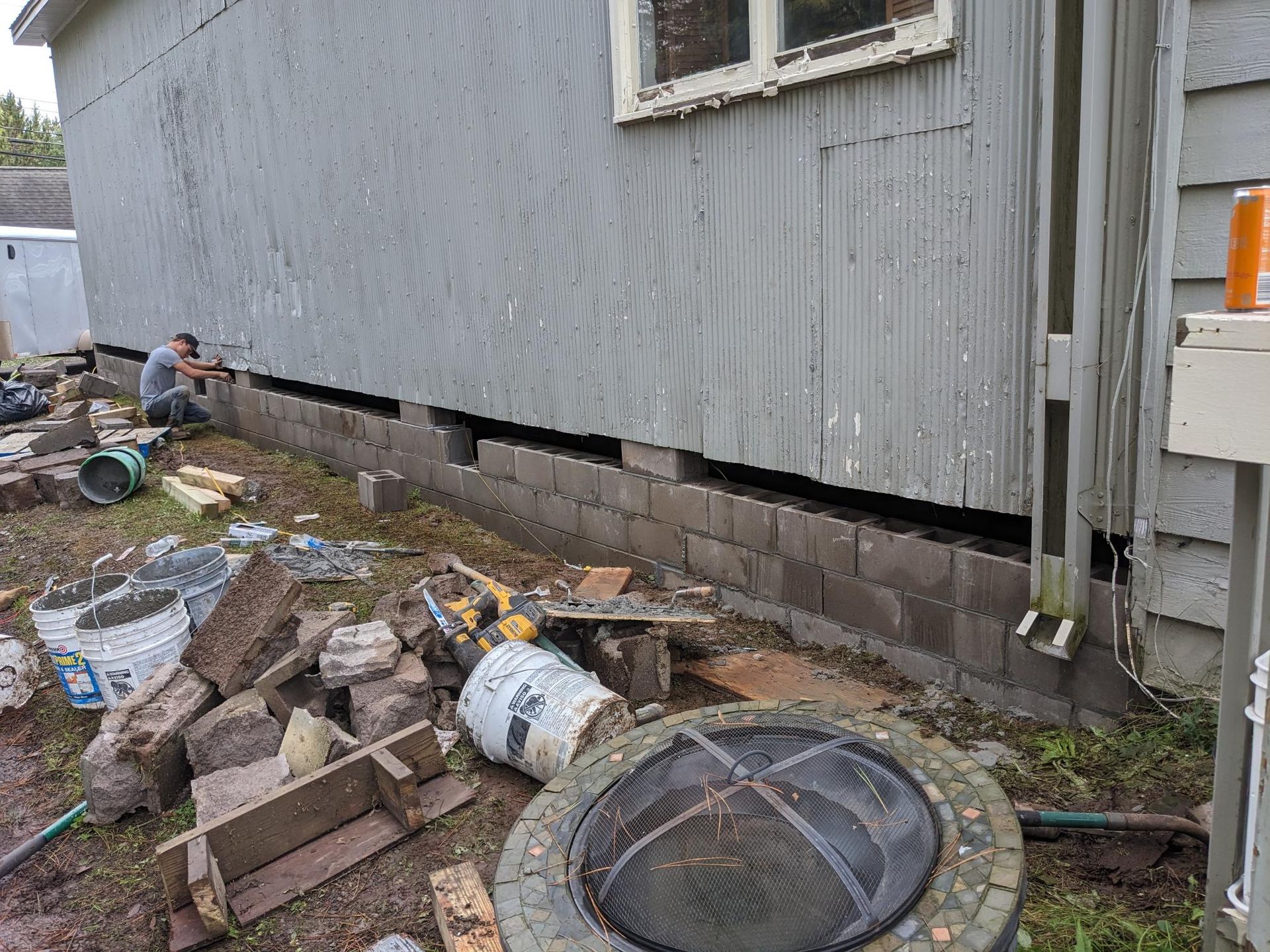 A man is working on the foundation of a house.