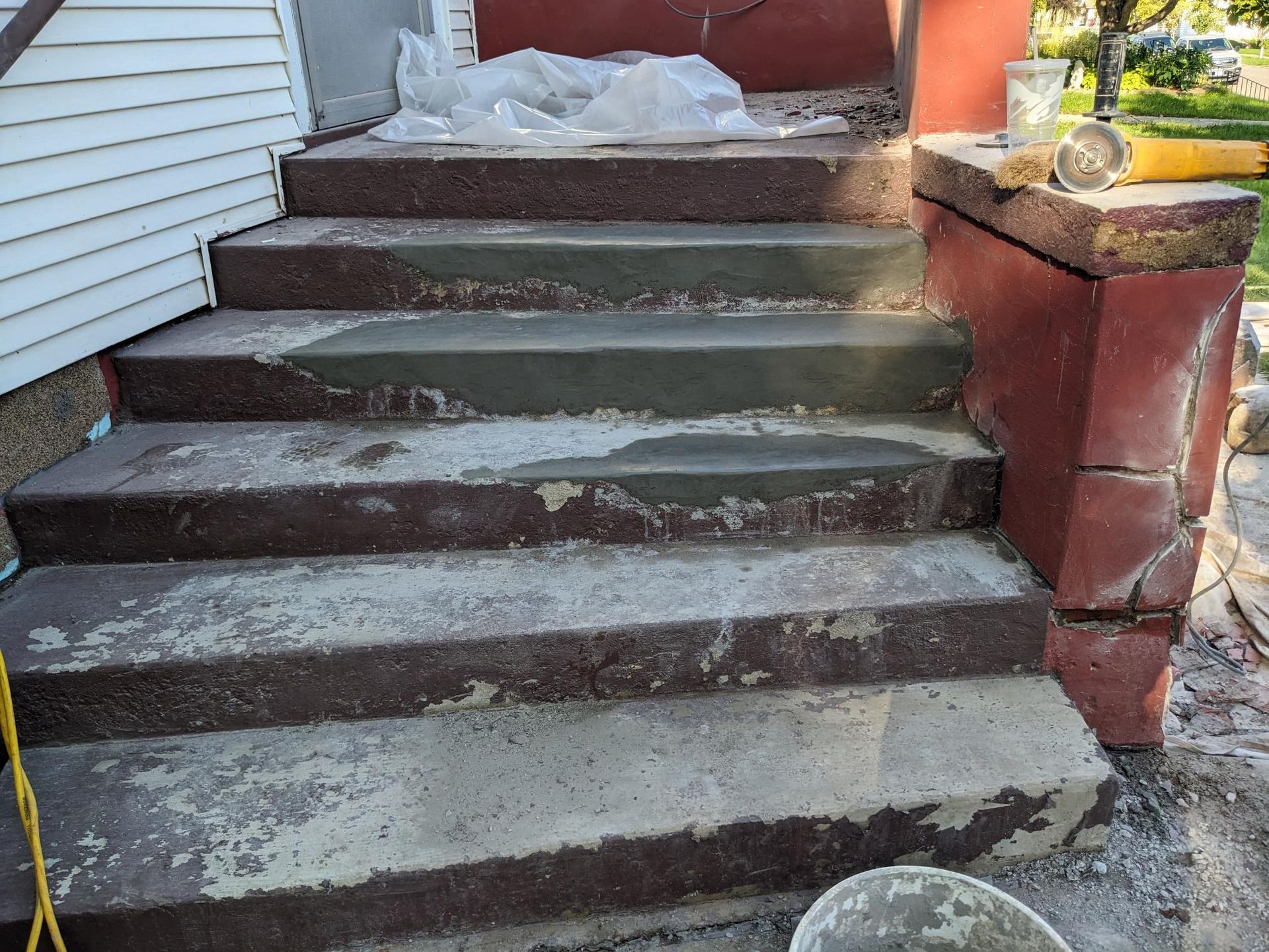 A set of concrete stairs that are being painted.