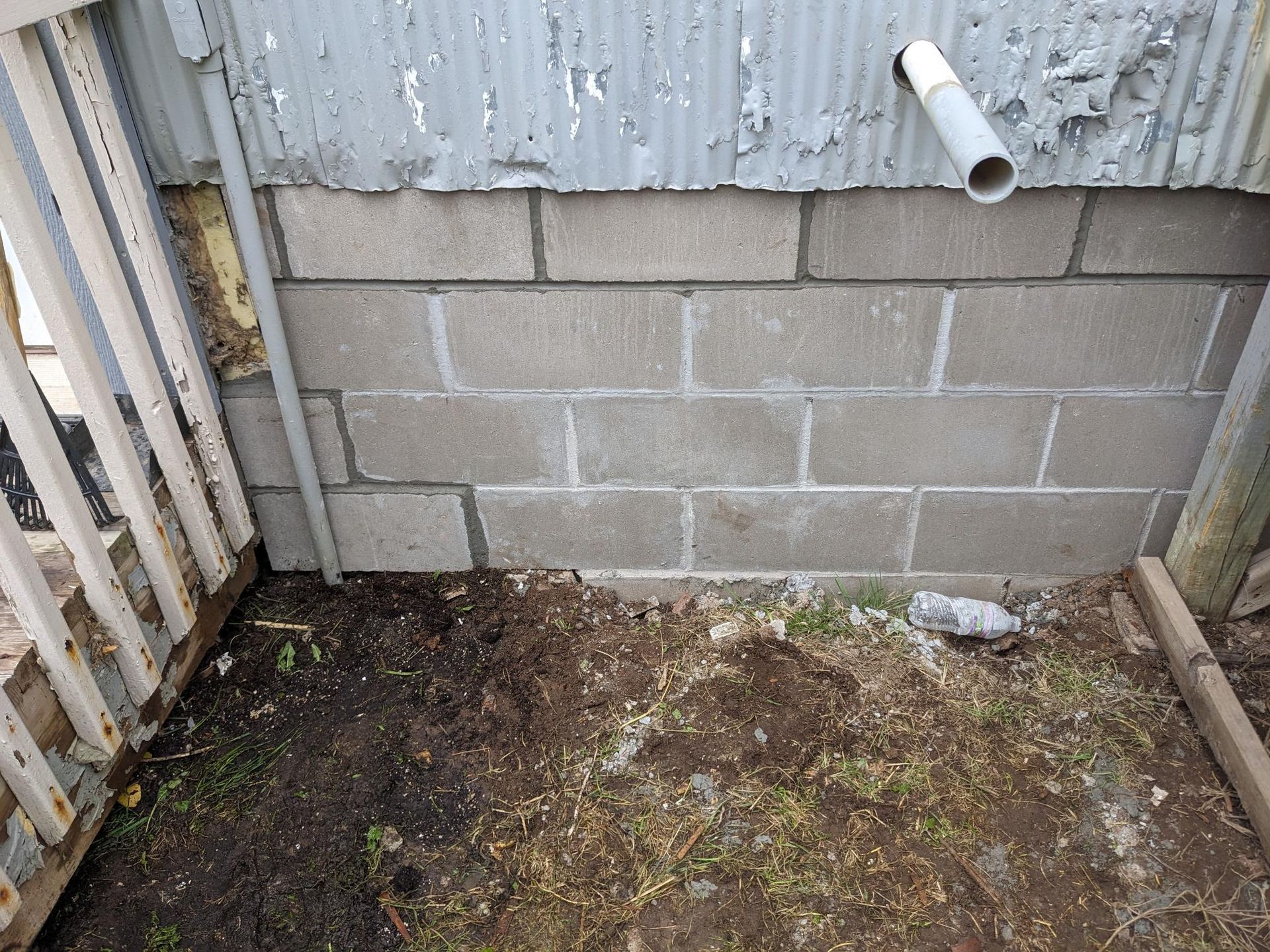 A brick wall with a pipe coming out of it