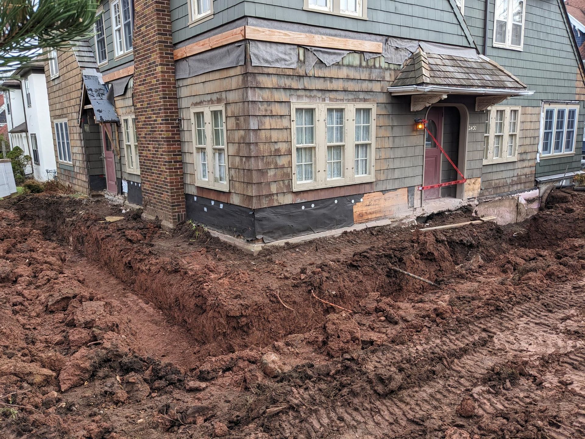 A house with a lot of dirt in front of it.