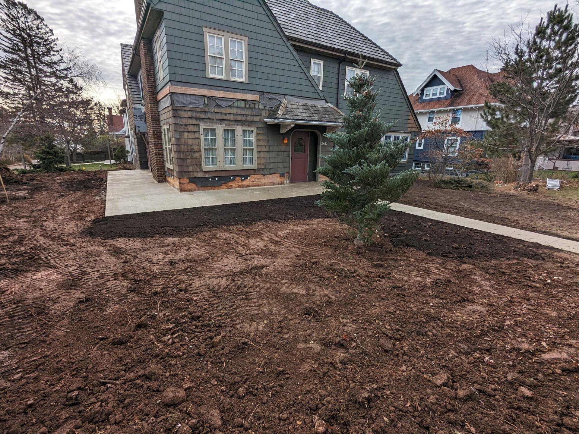 A large house with a lot of dirt in front of it.