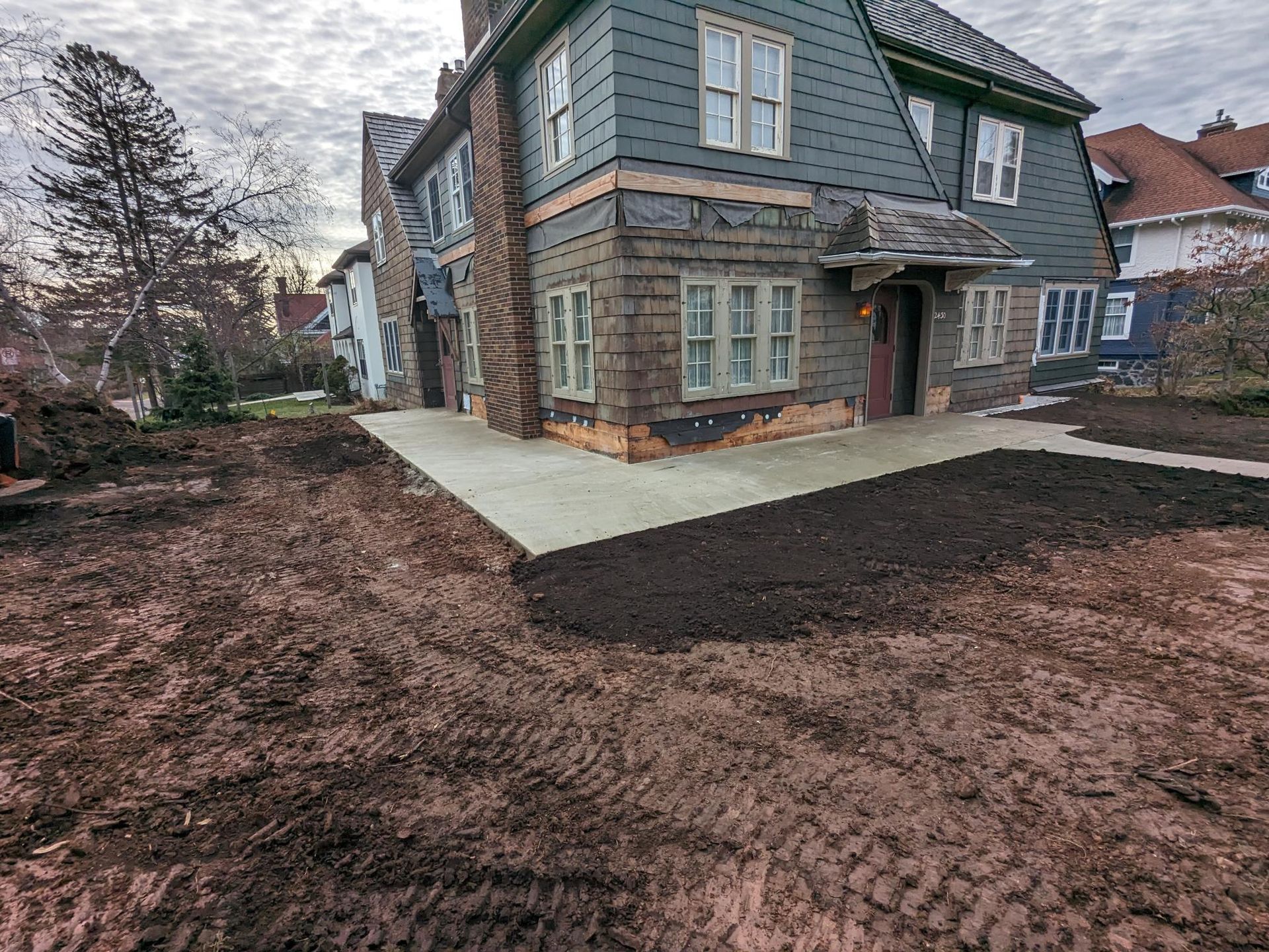 A large house with a lot of dirt in front of it.
