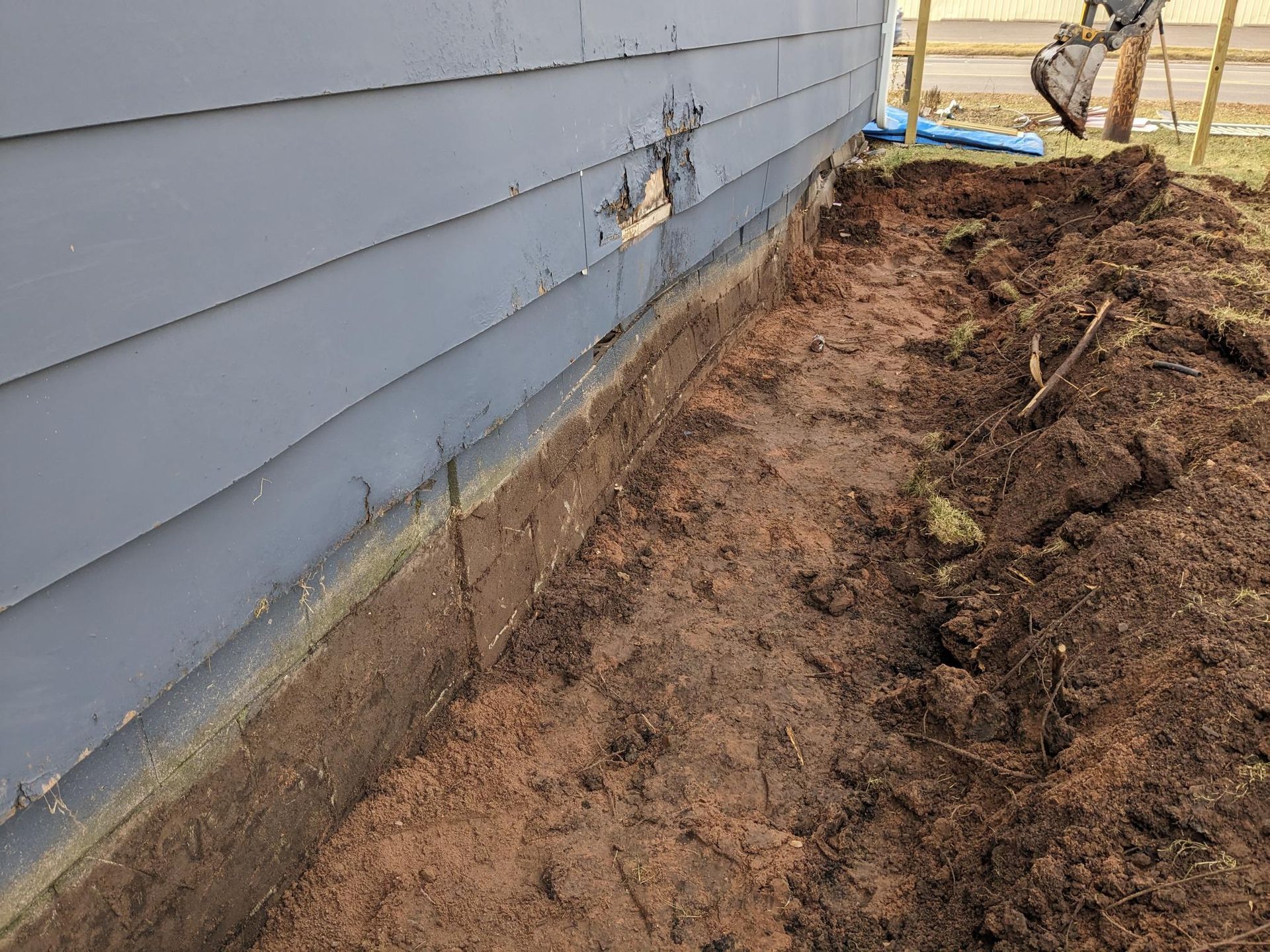 A pile of dirt is sitting in front of a house.