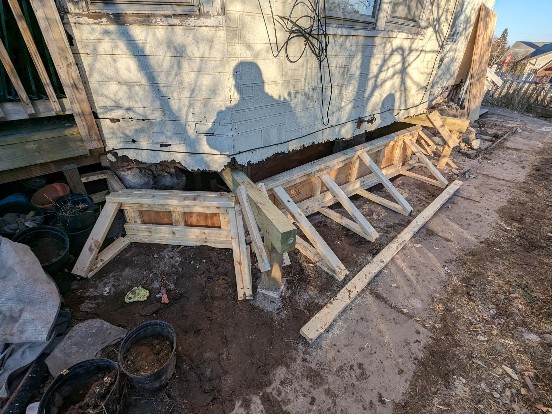 A wooden structure is being built in front of a house.