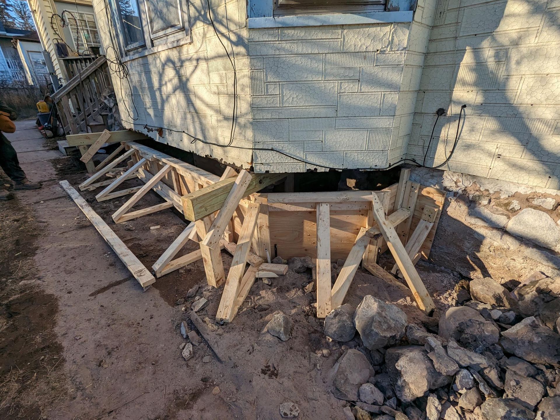 A house is being remodeled and a foundation is being built.