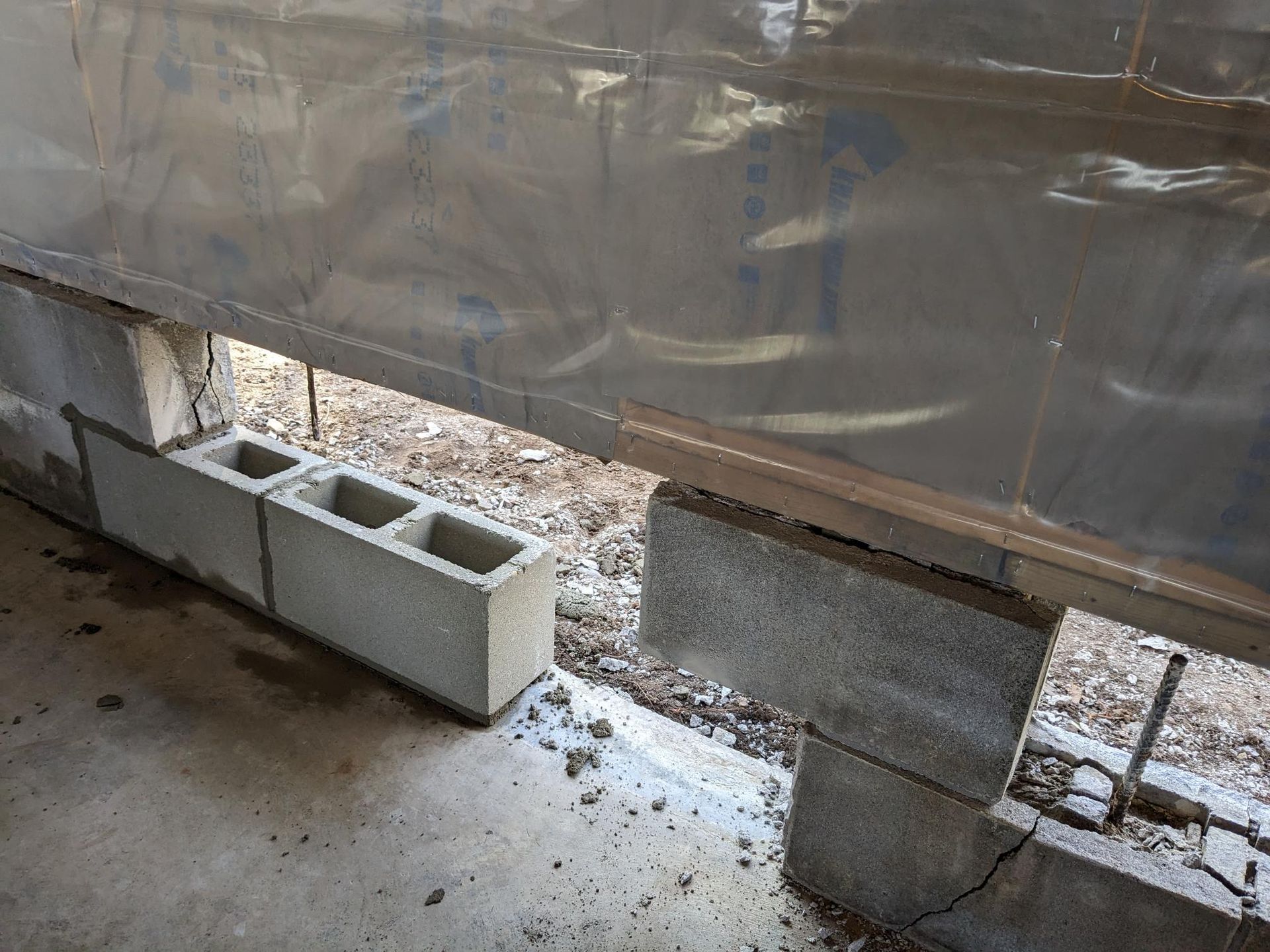A concrete block is sitting on top of a concrete floor next to a wall.