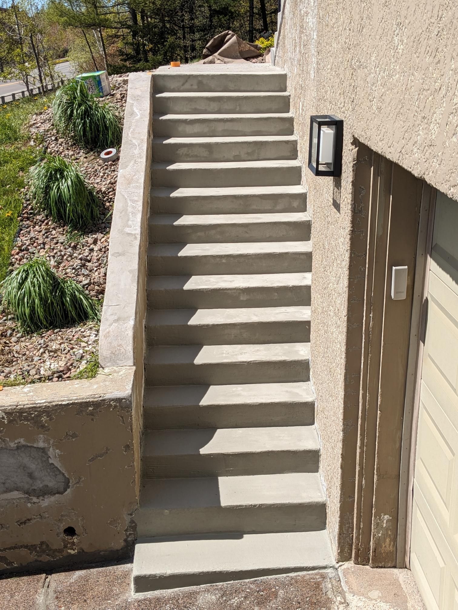 A set of concrete stairs leading up to a garage.
