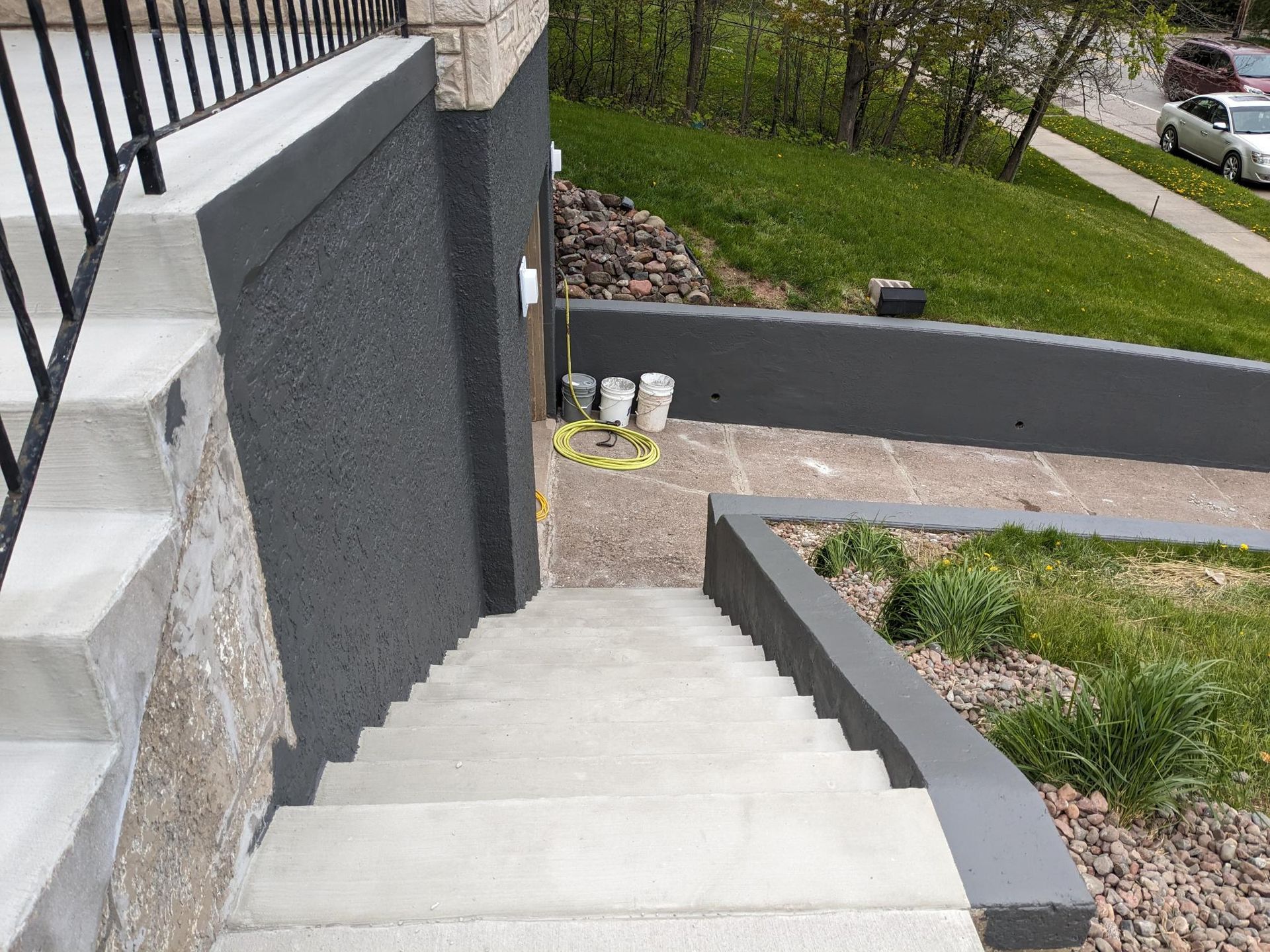 A set of stairs leading up to a building with a black wall.