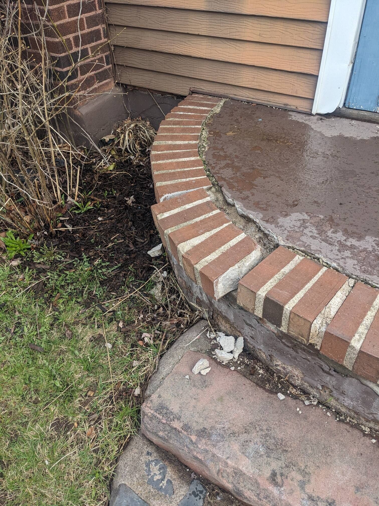 A brick walkway leading to the front door of a house.