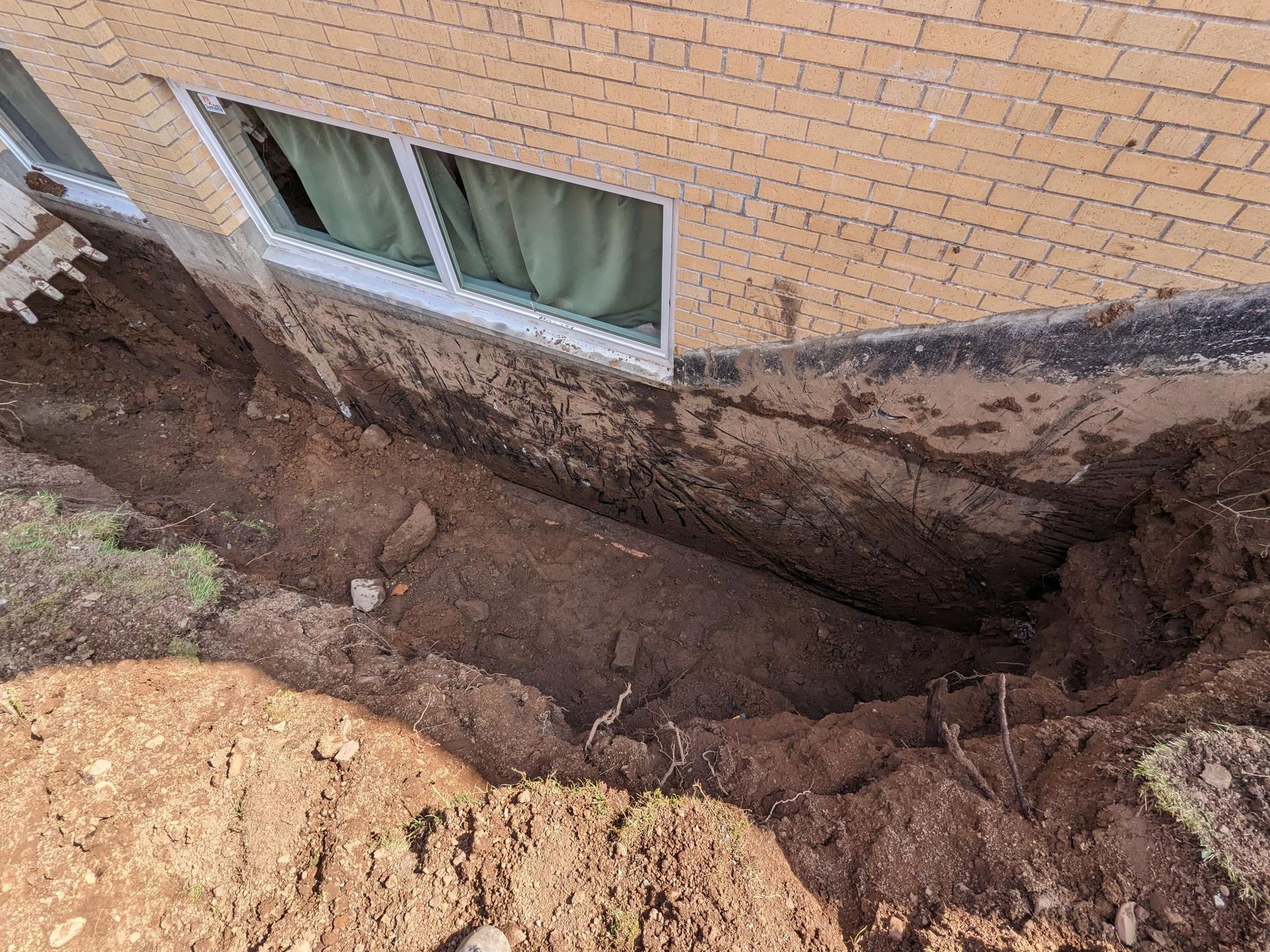 A hole in the side of a brick building with a window.