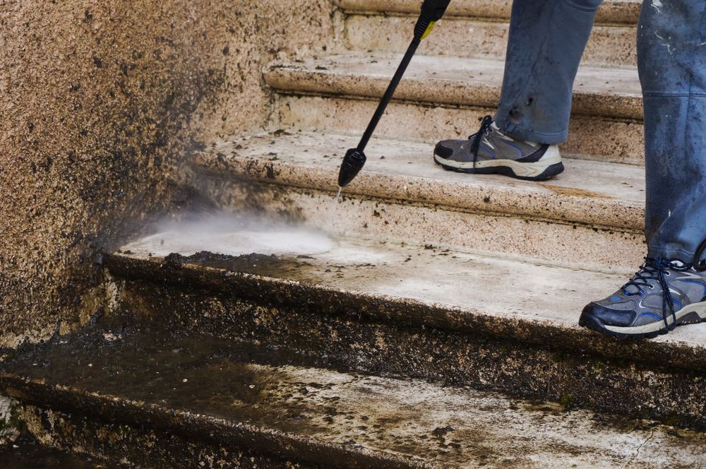 Person Power Washing Stone Steps — Coastal Pressure Solutions in Paradise Point, QLD
