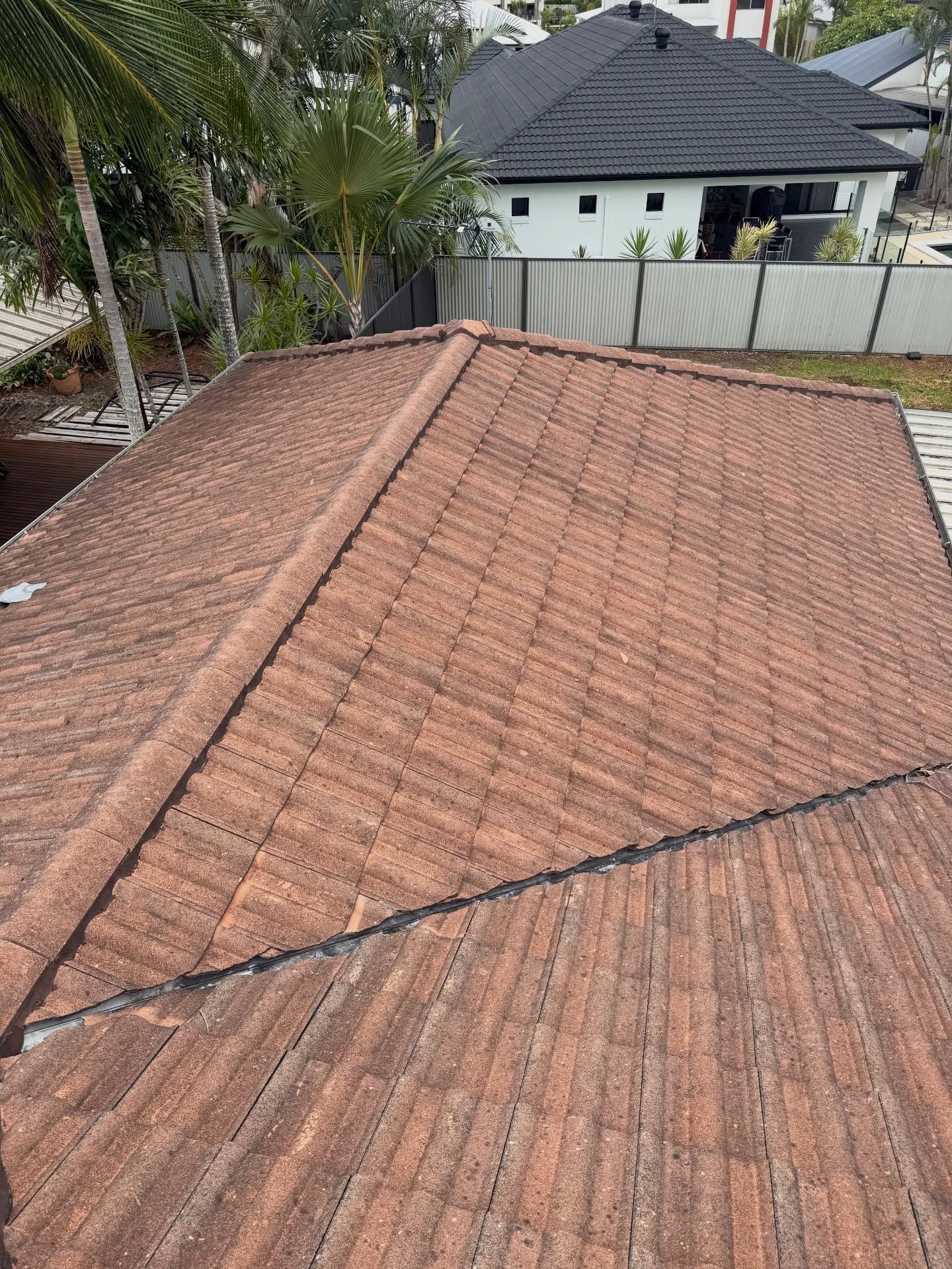 Brown Tiled Roof of a House With Visible Ridge — Coastal Pressure Solutions in Paradise Point, QLD