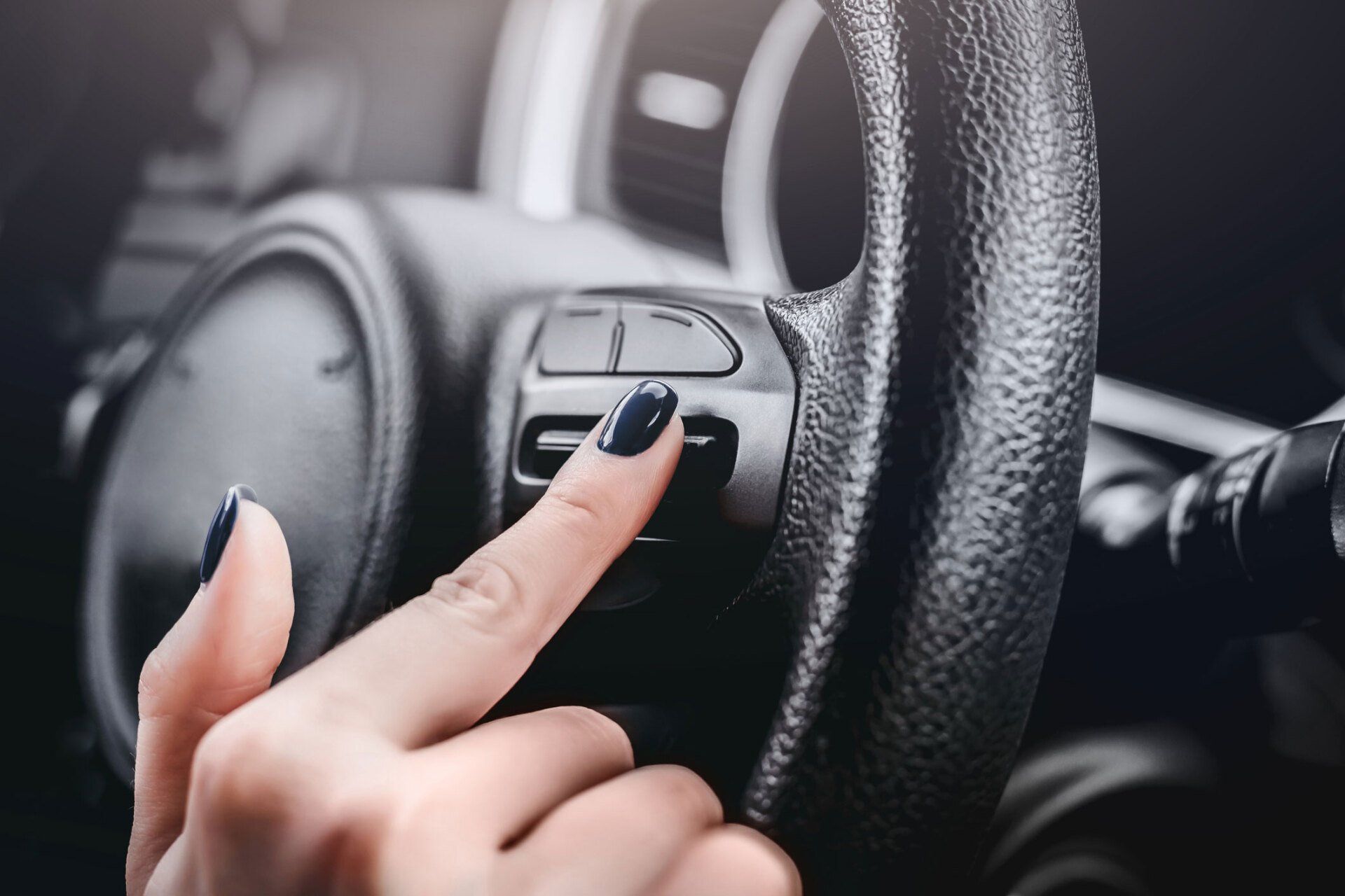 Woman Pressing Buttons on Steering Wheel — Slacks Creek, QLD — Jay Kay’s Auto Electrics