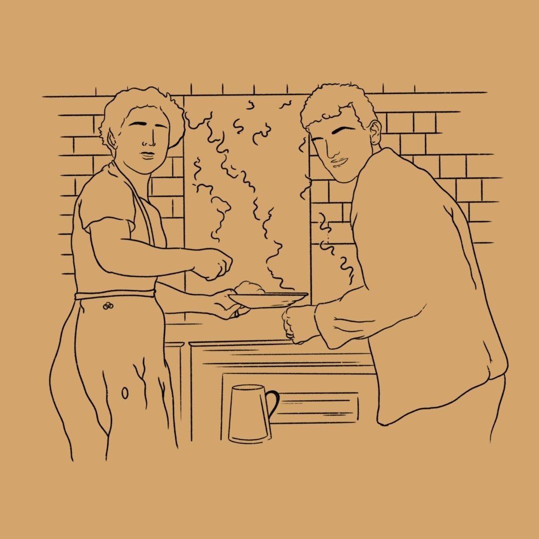 Due persone cucinano sui fornelli in cucina. Il vapore sale da una pentola.