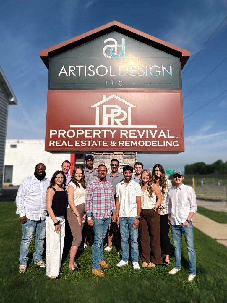 A group of people are posing for a picture in front of a sign.