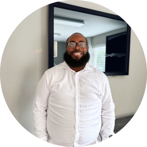 A man in a plaid shirt is smiling in a circle.