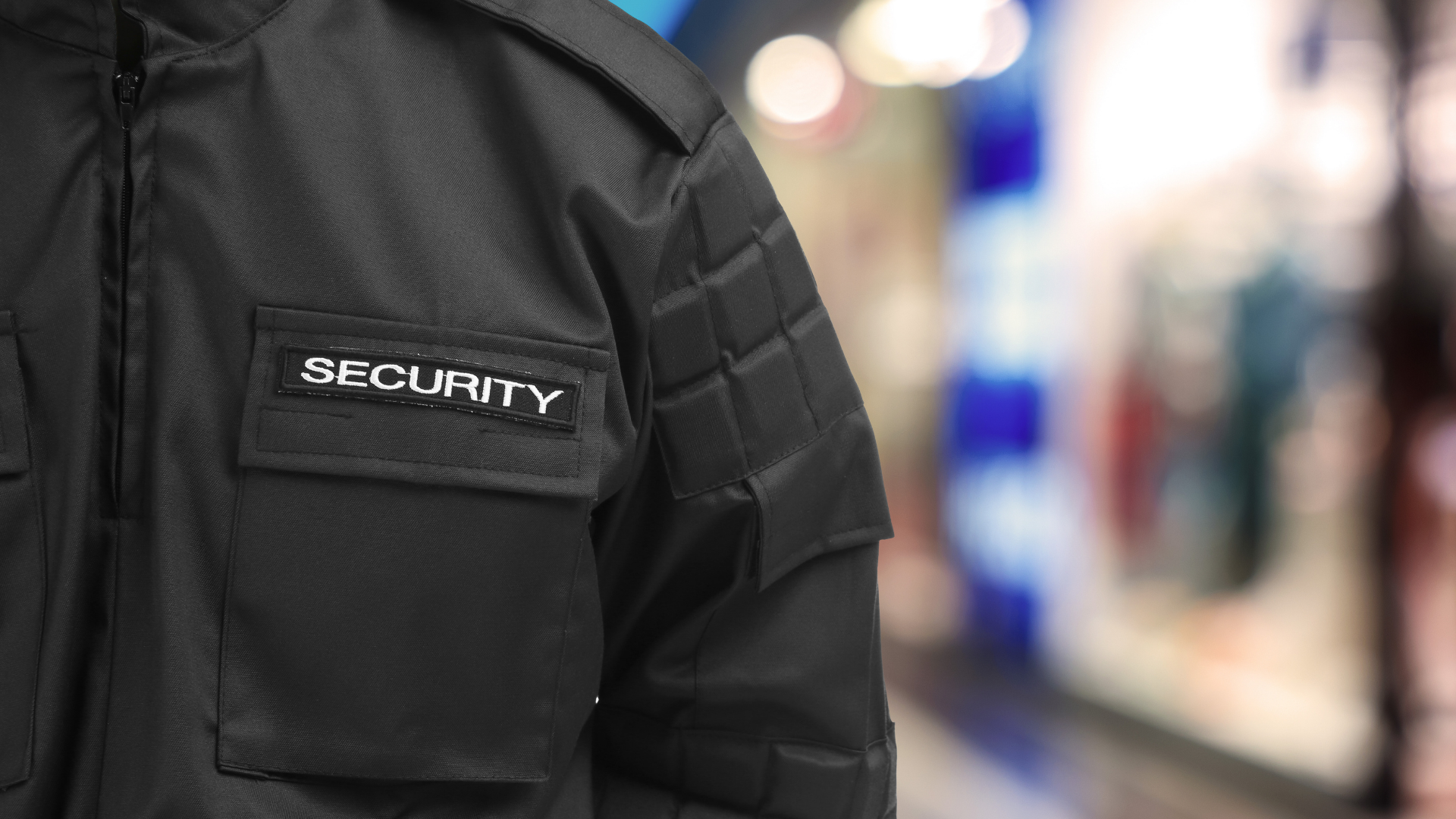 Close-up of a black security uniform jacket with a 