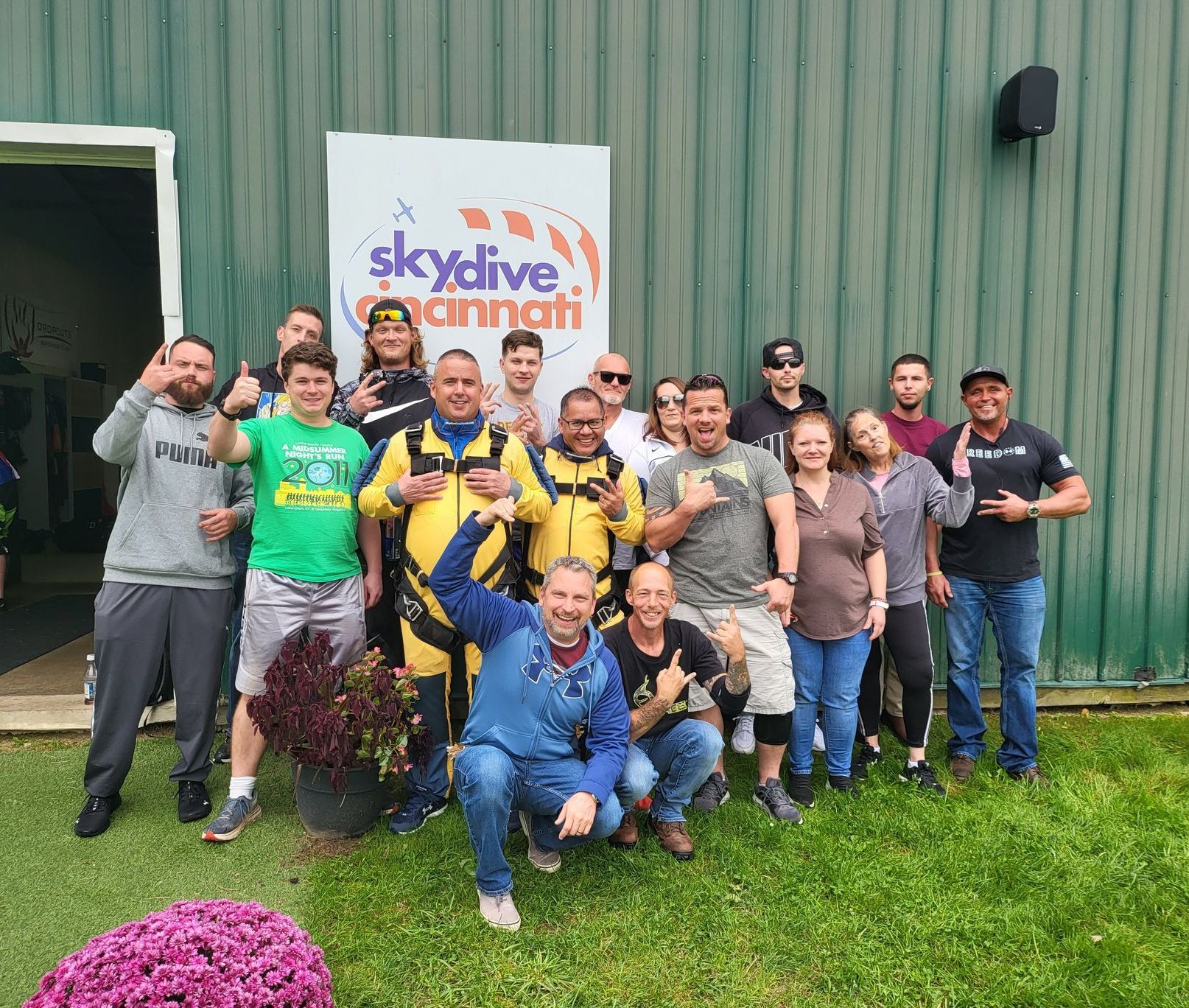 A group of people are posing for a picture in front of a building.