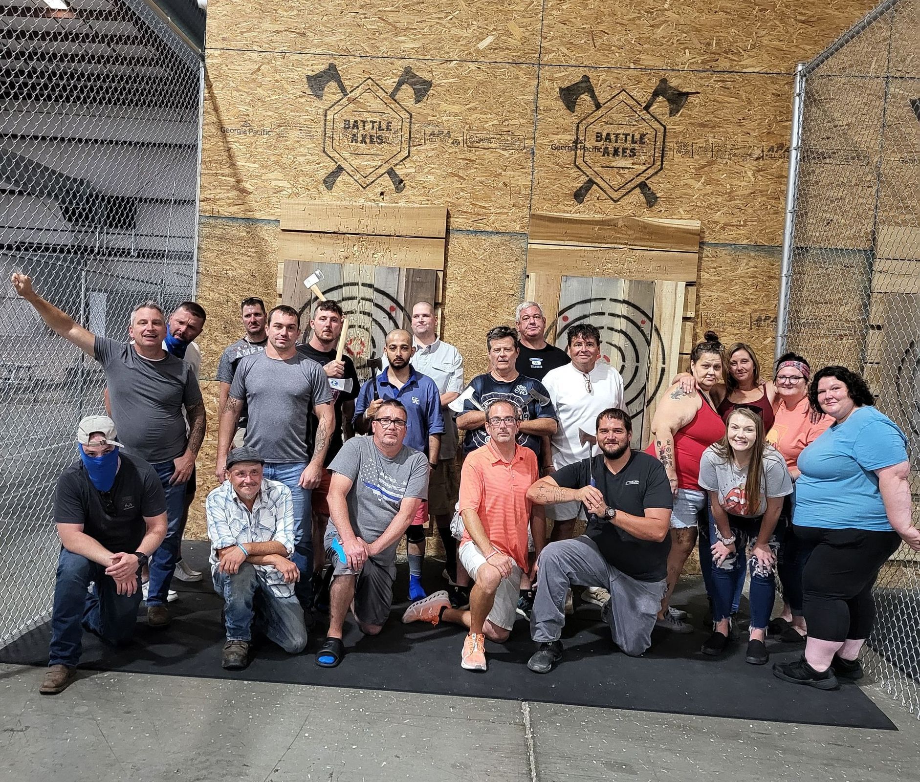 A group of people are posing for a picture in front of a building.