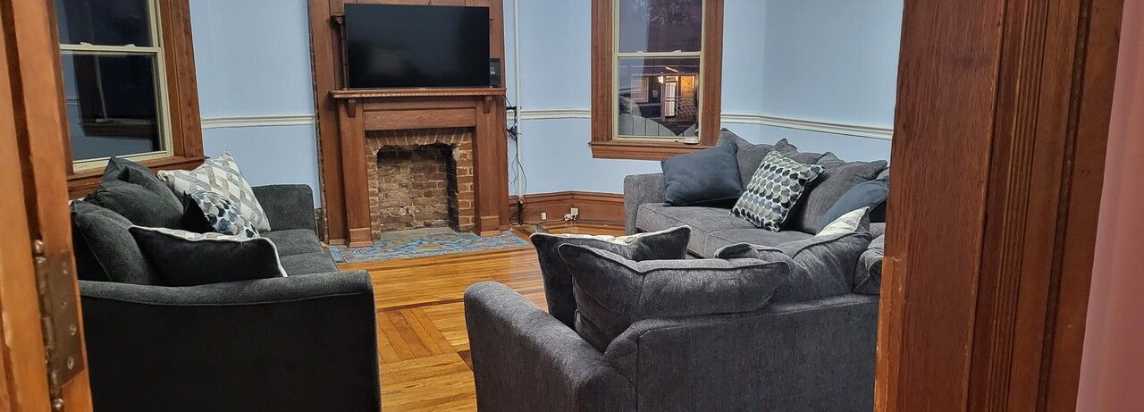 A living room filled with furniture and a fireplace.
