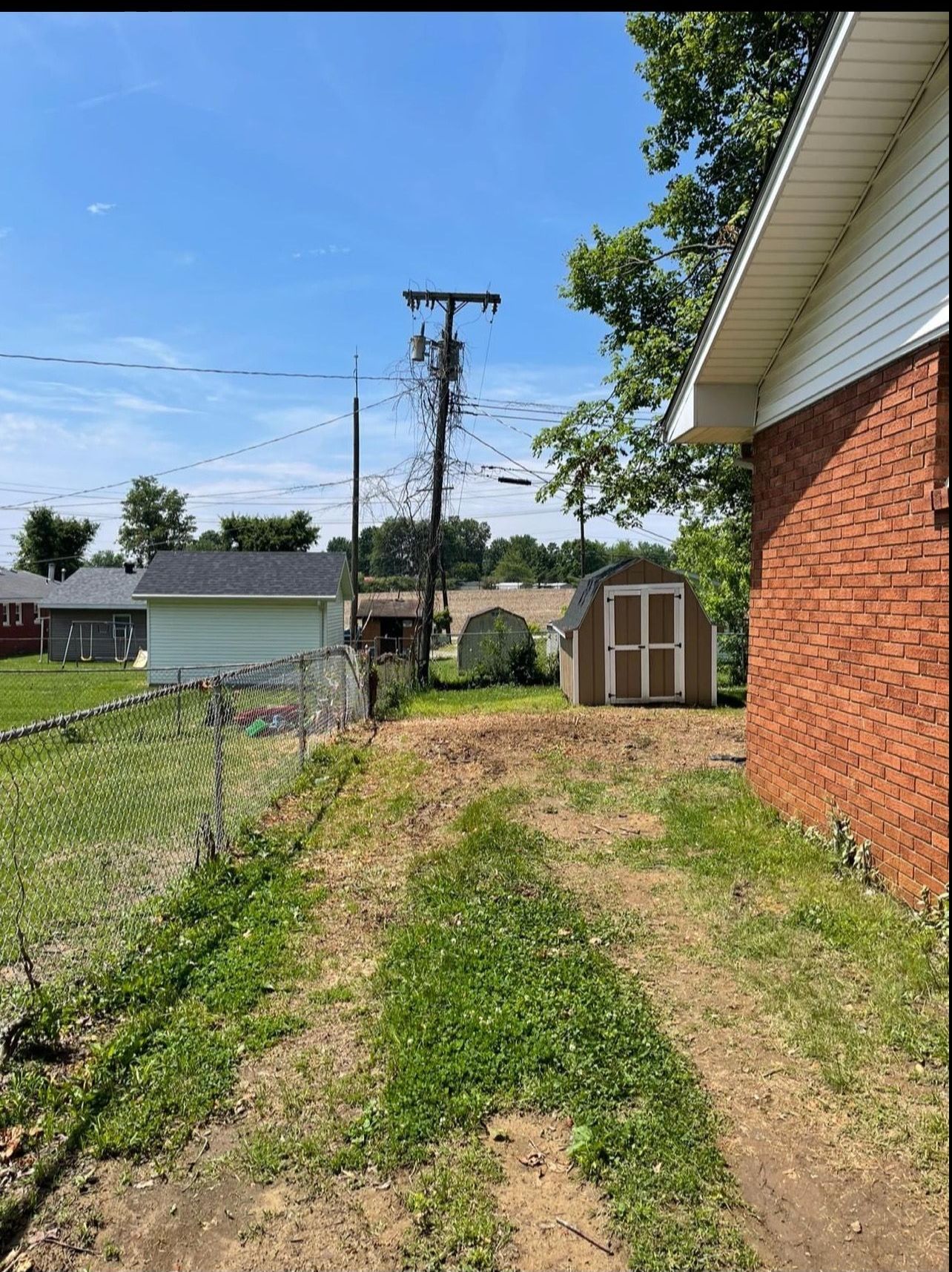 There is a shed in the backyard of a house.
