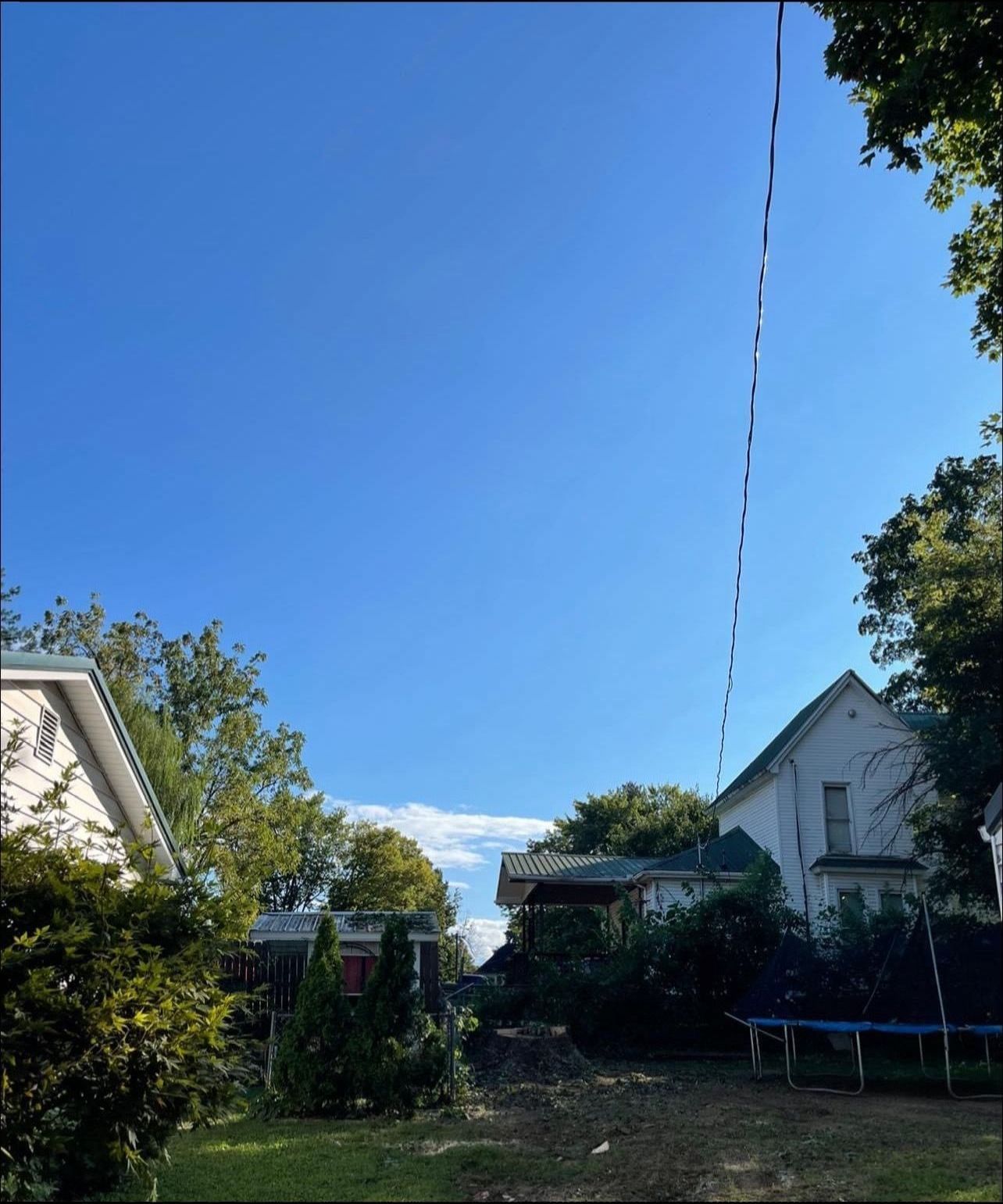 A house with a trampoline in front of it