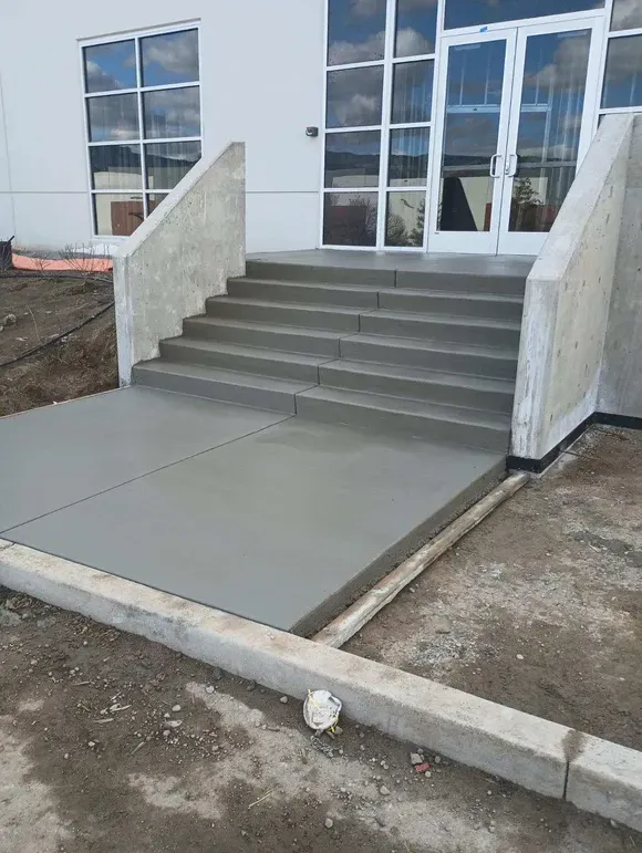 A set of concrete stairs leading up to a building.