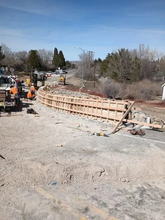 A group of construction workers are working on a road.