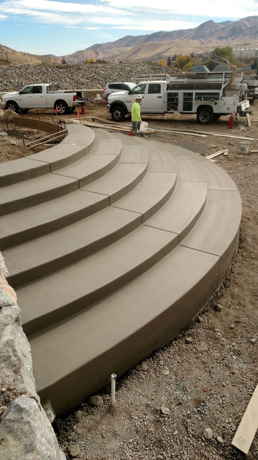 A concrete staircase is being built in a dirt field.