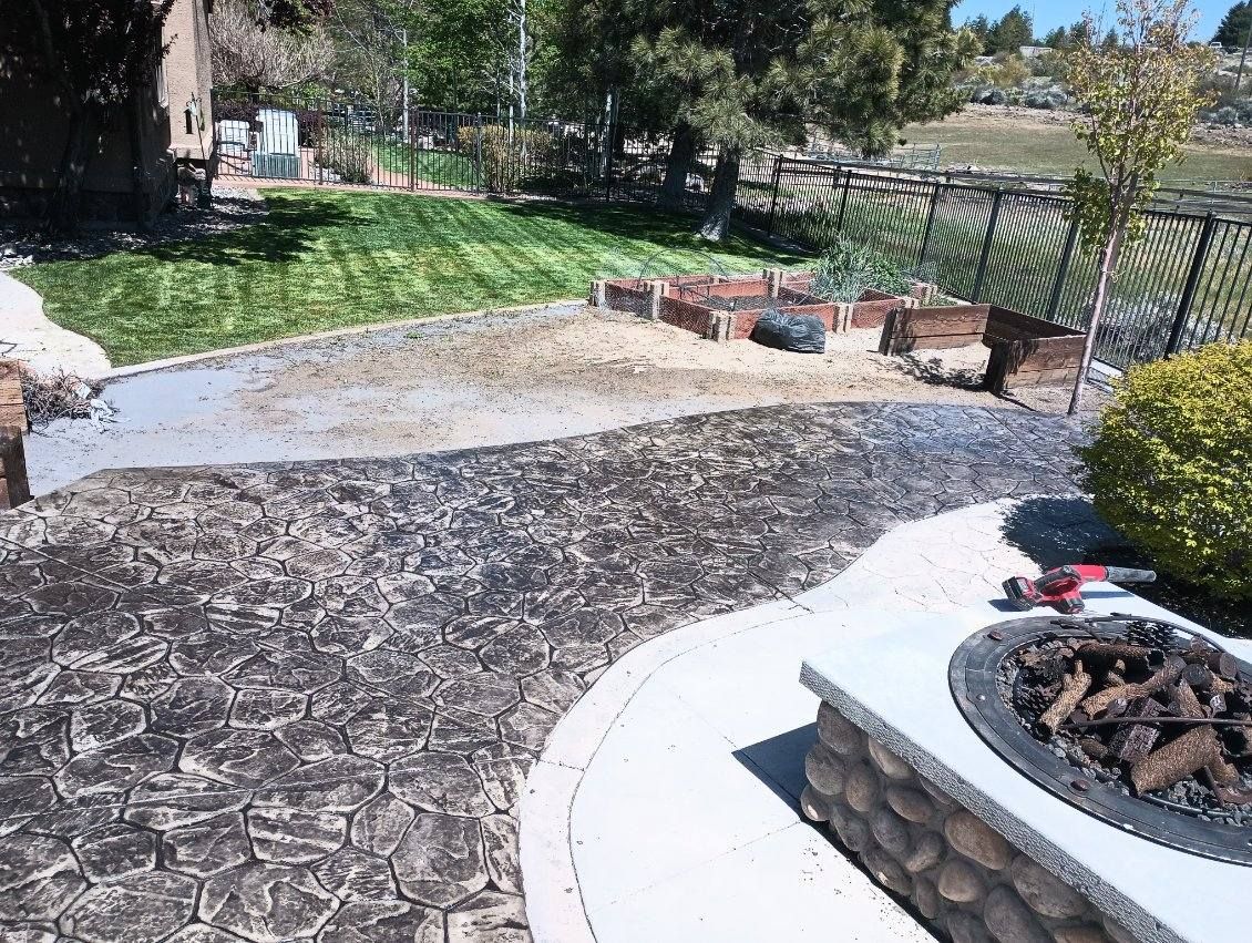 There is a fire pit in the middle of the backyard.