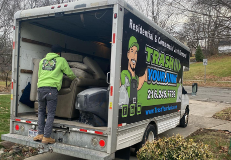 pile of furniture in someone's driveway that reads furniture removal cleveland, ohio