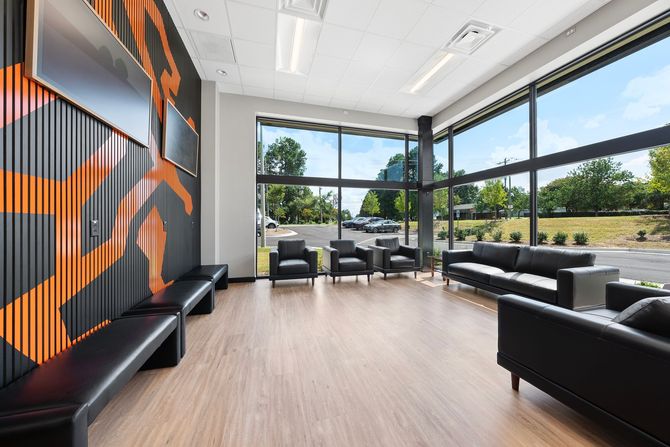 A gray-walled office space with a counter and stool; view into the Torque marketing office. | Torque European Car Care