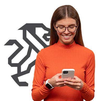 Woman wearing glasses and orange shirt smiles while looking at her phone; a gray lion logo is in the background. | Torque European Car Care