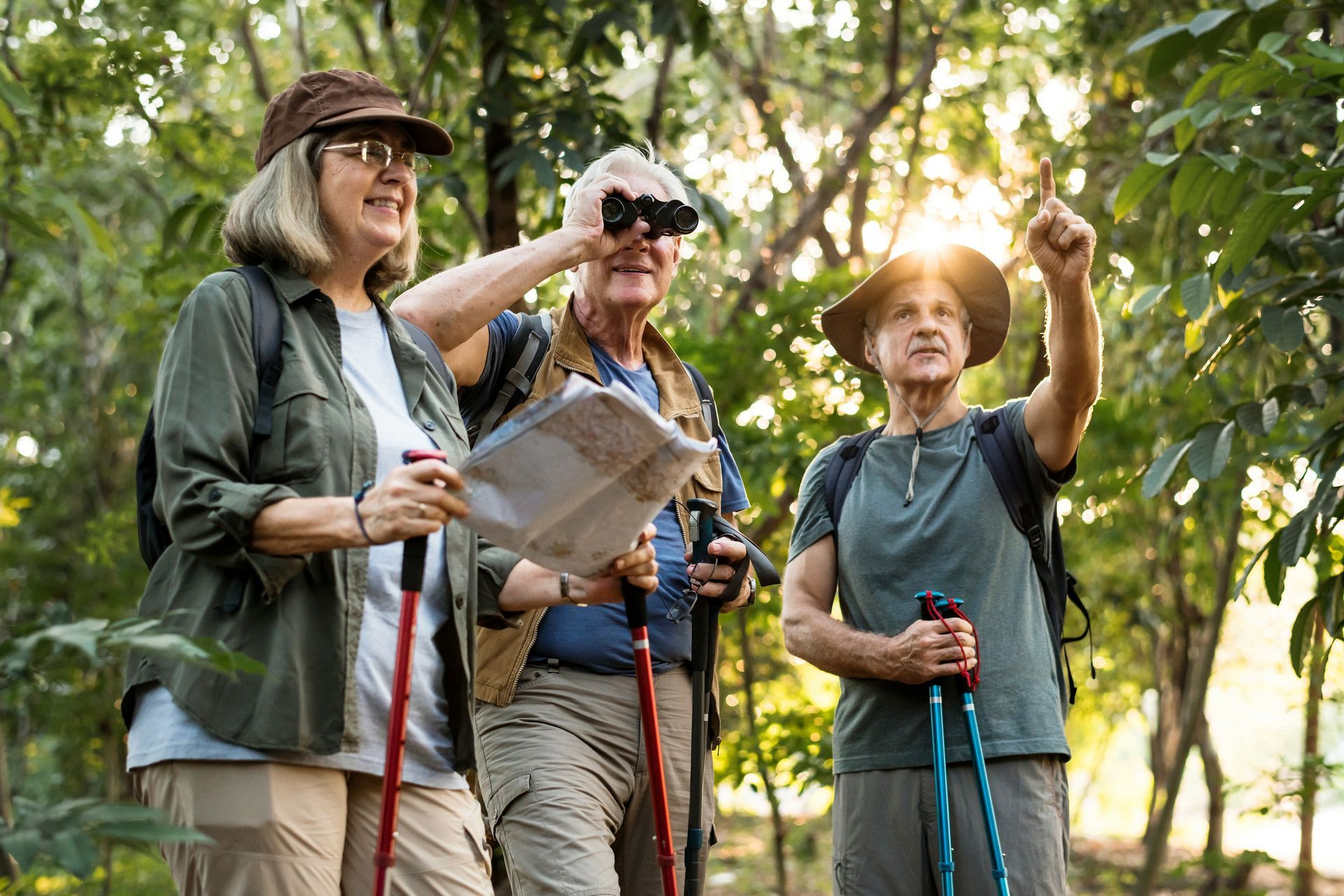 A woman in a graduation cap and gown is taking a selfie with her mother.