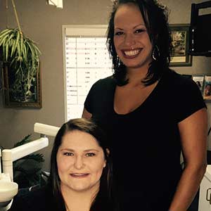 two hygienists in a treatment room