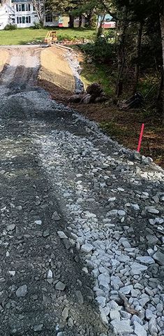 A dirt road with a lot of rocks on the side of it.