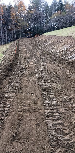 A dirt road with a lot of tire tracks on it.