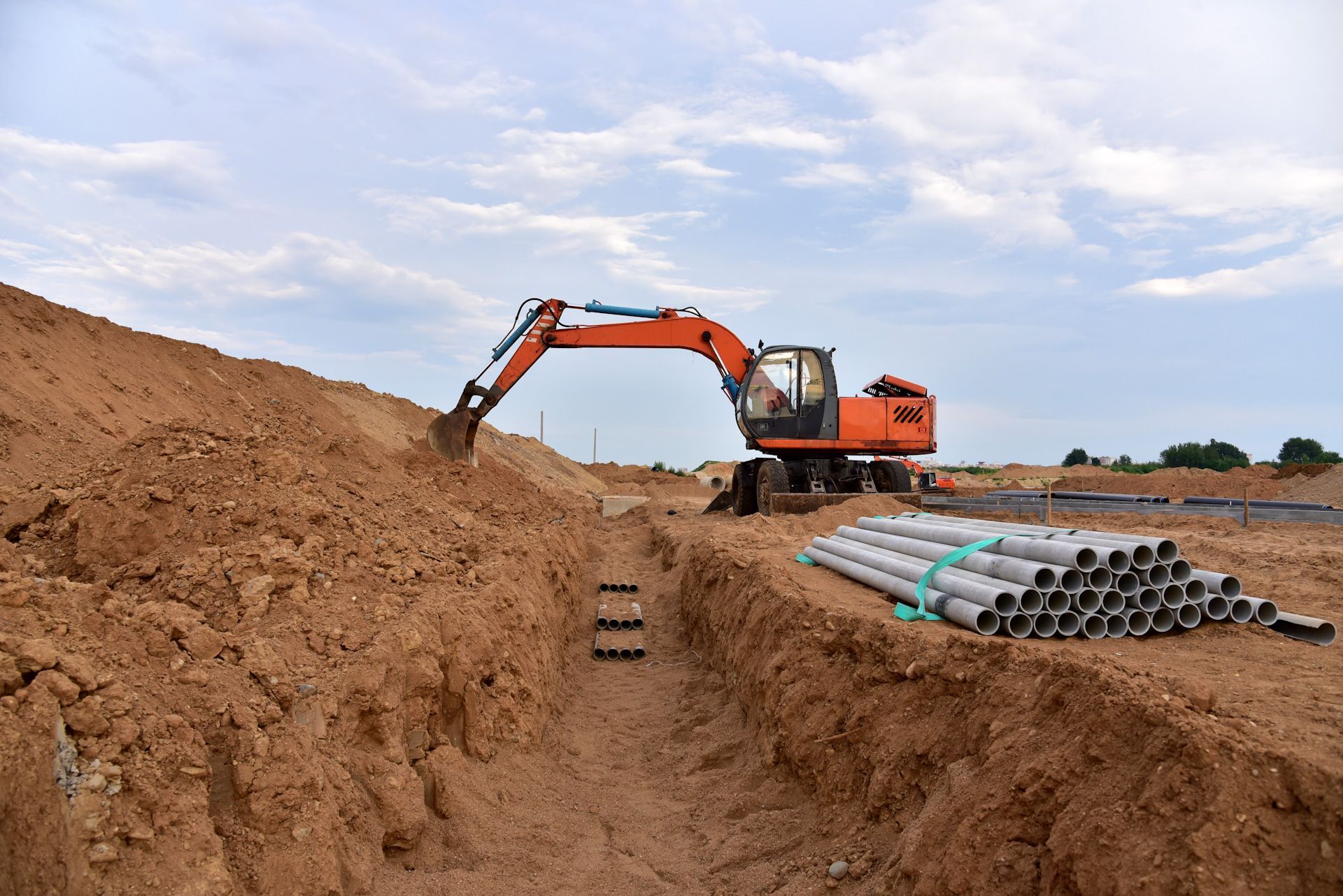 A bulldozer is digging a hole in the dirt at a construction site.