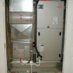 A picture of an air conditioner in a closet.