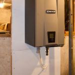 A large gray box is hanging on a white wall.