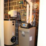 A room with a water heater and a water softener in it.