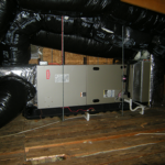 A machine is sitting under a ceiling in a room.