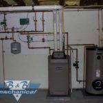 There is a boiler and a water heater in the basement.