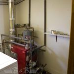 A laundry room with a stove and a washer and dryer.