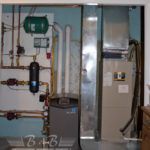 A room with a furnace and a heater in it.